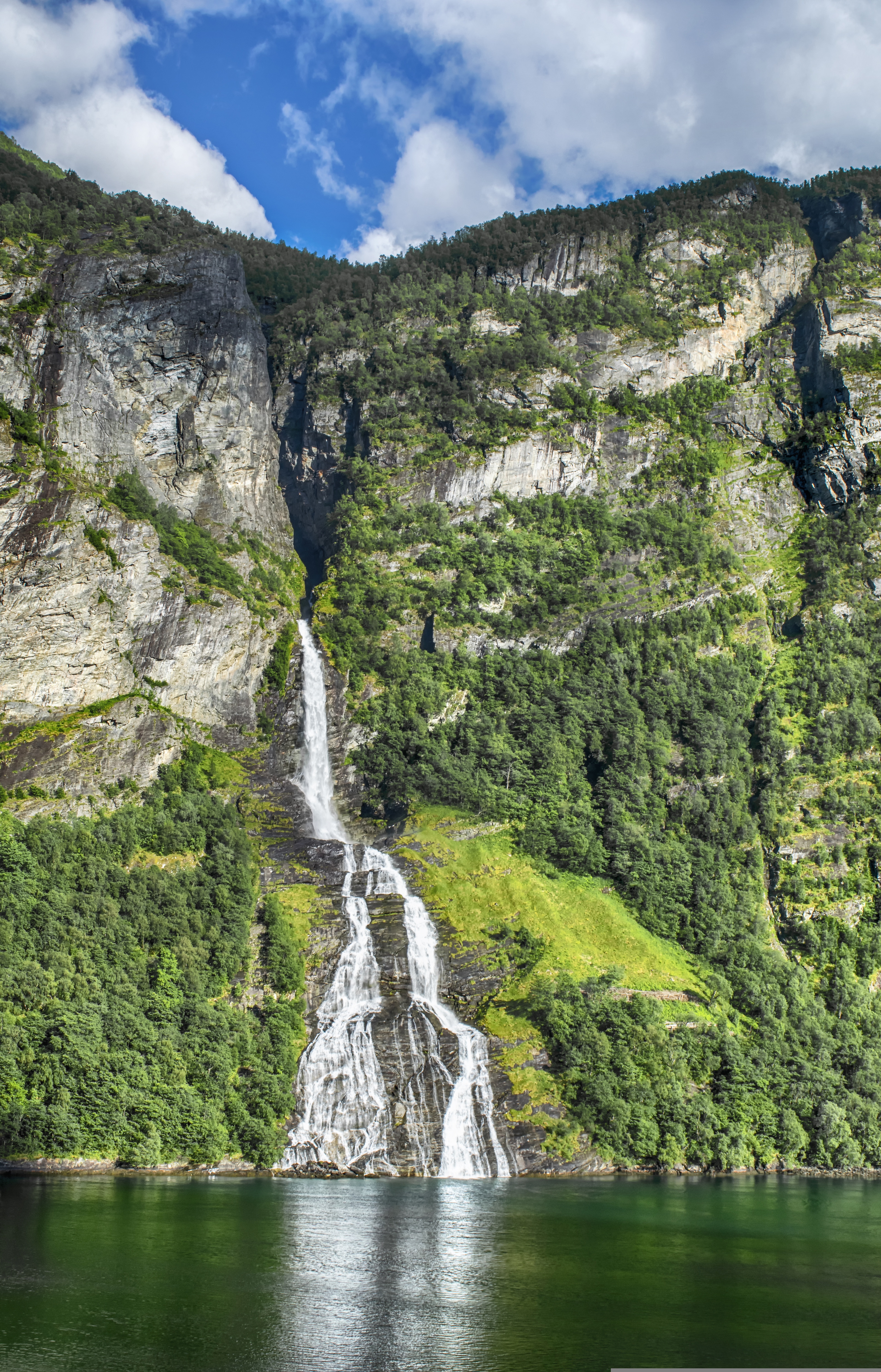 Geirangerfjord waterfall cascading down the cliff wall, seen from water level