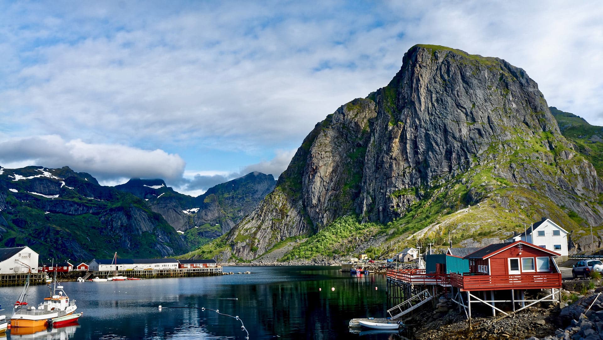 Lofoten Islands red rorbuer cabins against dramatic mountain backdrop