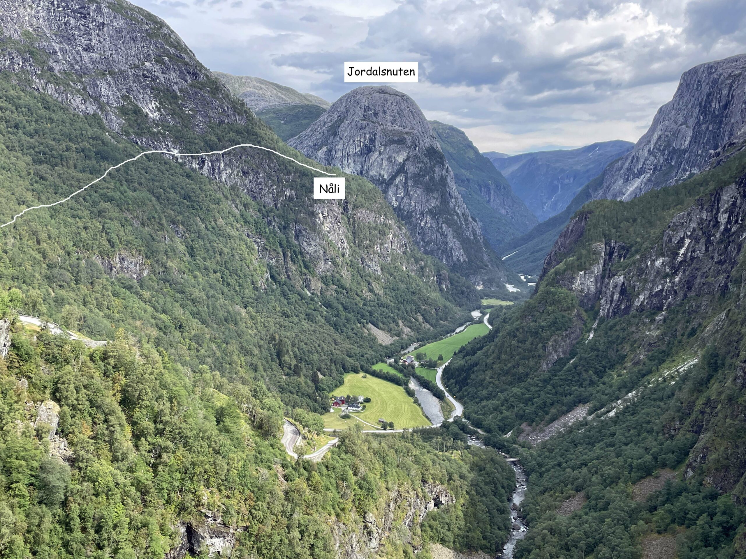 View down Nærøydalen valley from the Nåli viewpoint above Stalheim, green valley floor and steep rock walls on both sides