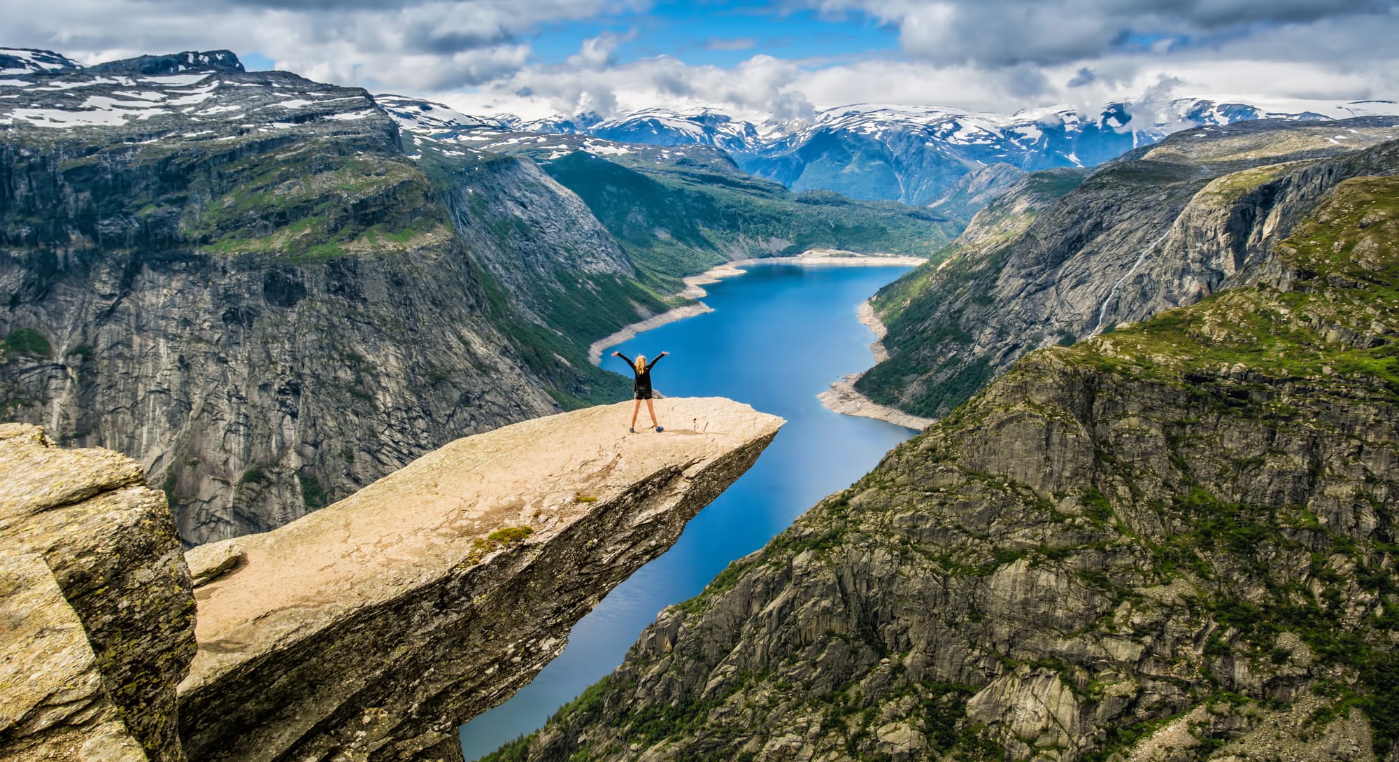 Preikestolen (Pulpit Rock), the flat rock shelf 604 metres above the Lysefjord near Stavanger, seen from the trail with the fjord far below the unfenced edge